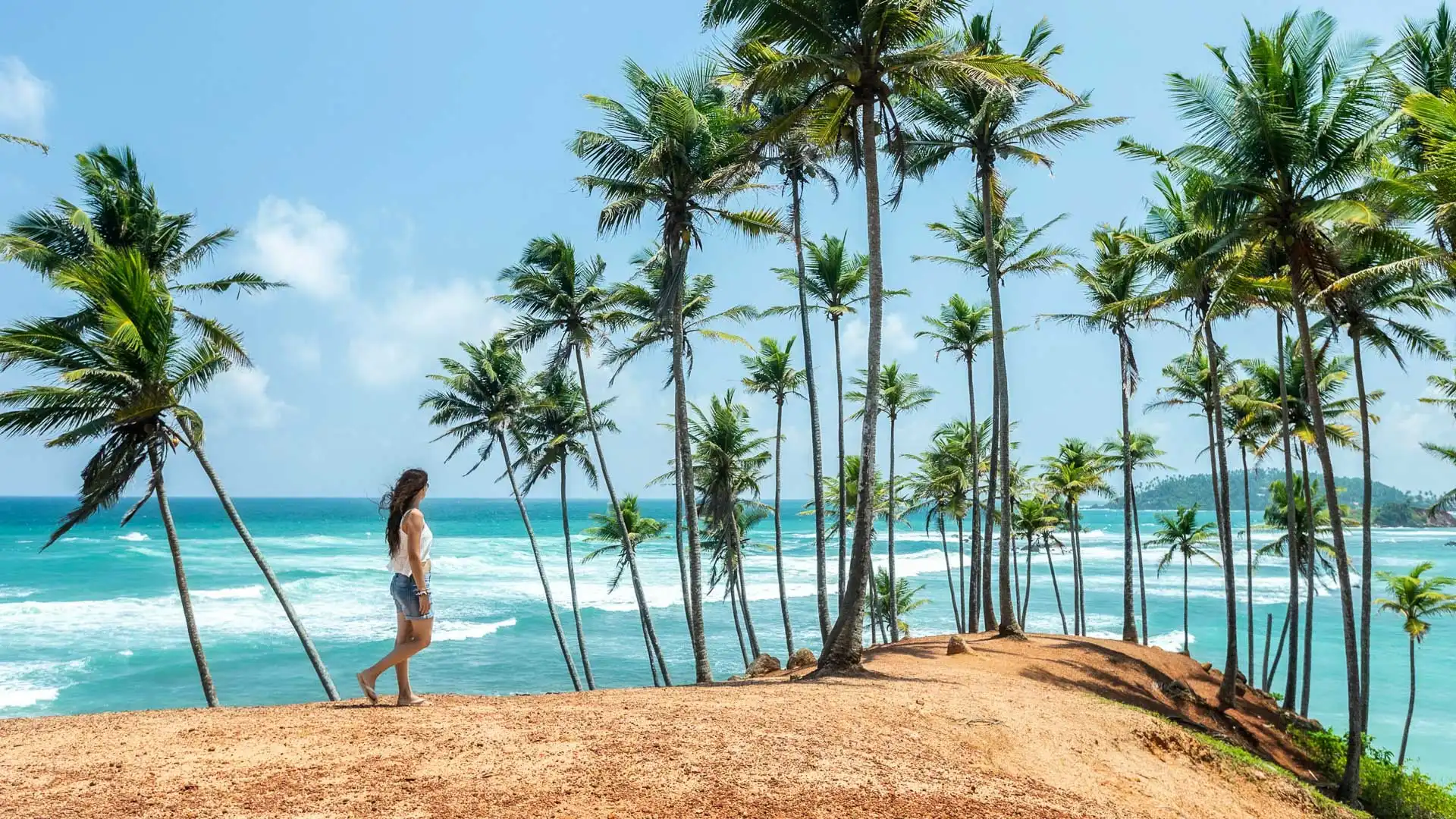 A desk with a travel journal, glasses, and photos